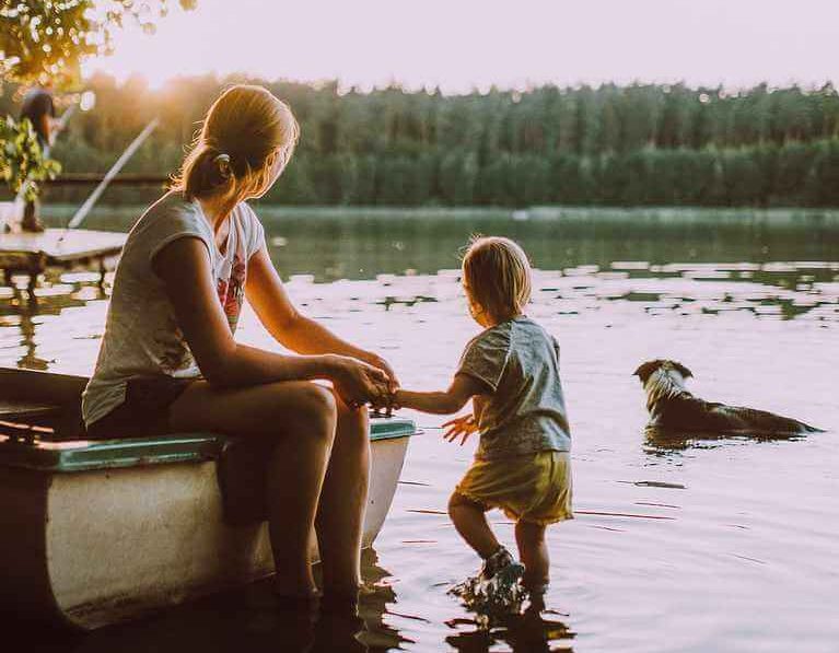 Schülerkonto vergleichen, Mutter mit Kind und Hund an See